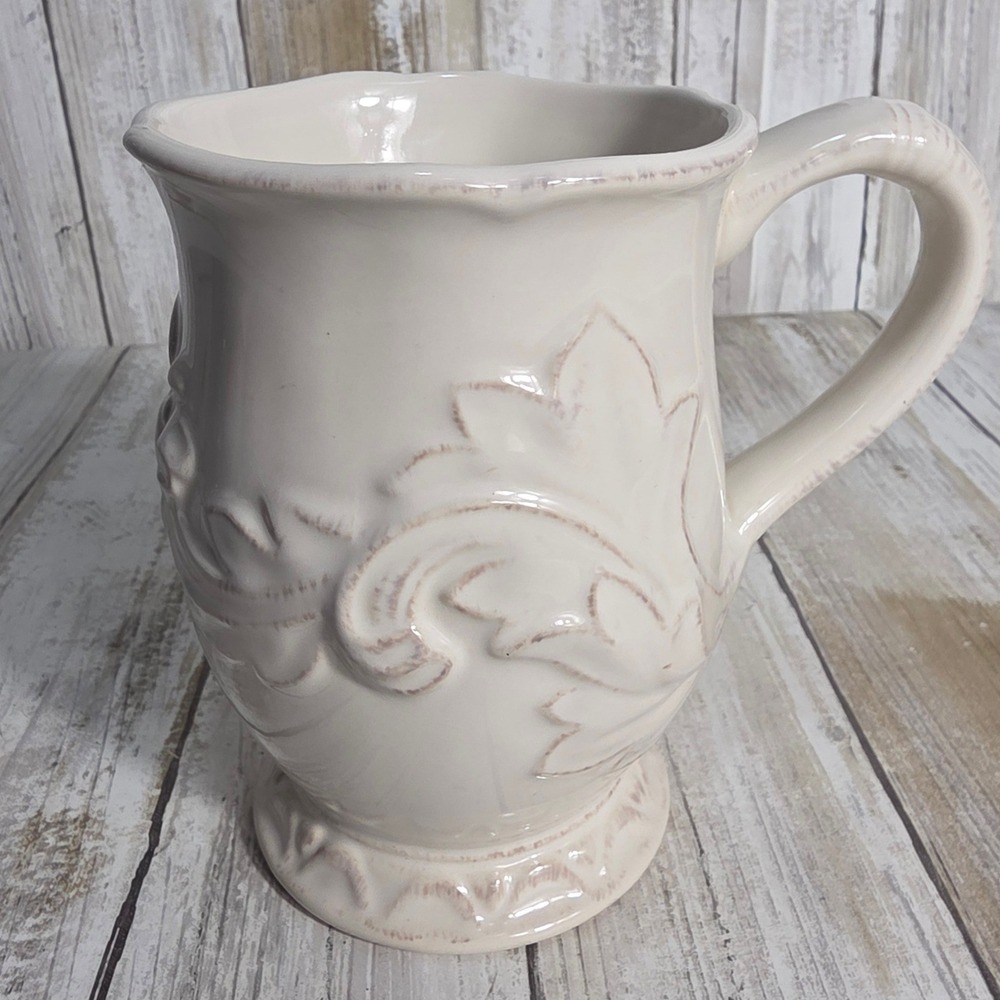 Certified International Cream Embossed Acanthus Leaf Ceramic Coffee Mug Pedestal